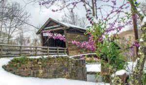 Humpback Bridge in early spring with snow and redbuds