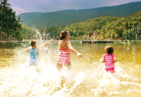 kids splashing water at the lake