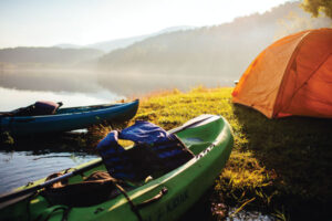 docked kayaks by tent